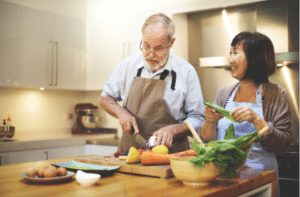 Cooking elderly couples in the kitchen